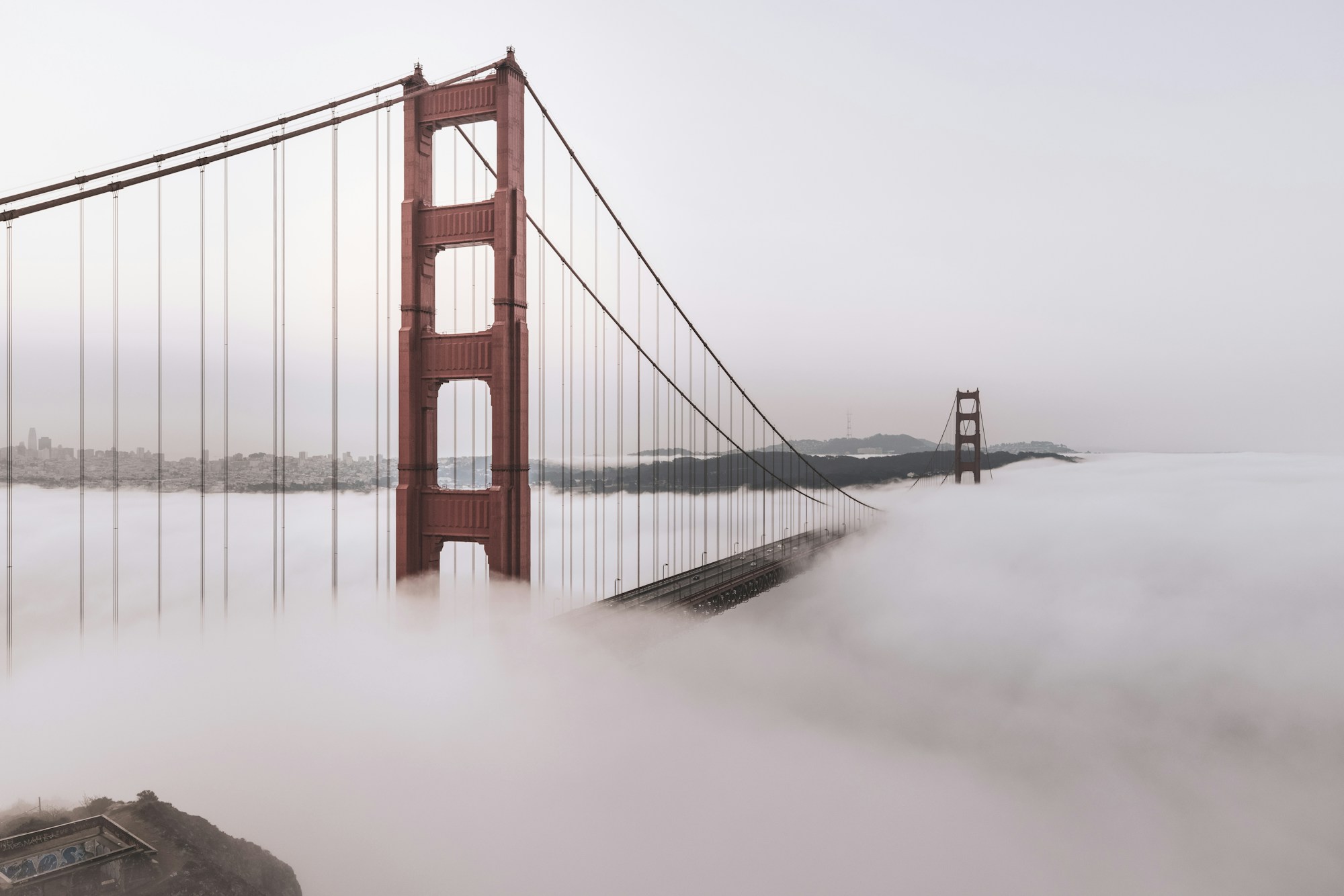 The Golden Gate Bridge emerging from a soft bank of fog